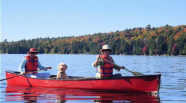 Labradoodle with her mums in a canoe